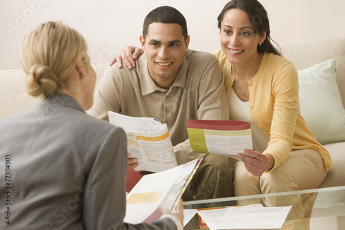 Photo: Hispanic couple receiving financial consultation Hispanic couple receiving financial consultation