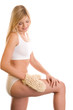 Woman massaging her leg with sisal glove