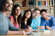 Smiling group of students in a library Smiling group of students in a library