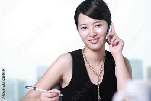 Photo: young asian business woman writing something young asian business woman writing something