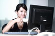 Photo: young asian businesswoman working with computer in office young asian businesswoman working with computer in office