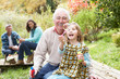 Photo: Grandfather And Granddaughter Blowing Bubbles On Family Picnic Grandfather And Granddaughter Blowing Bubbles On Family Picnic