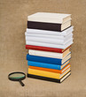 Pile of books and magnifying glass - Educational still life Pile of books and magnifying glass - Educational still life