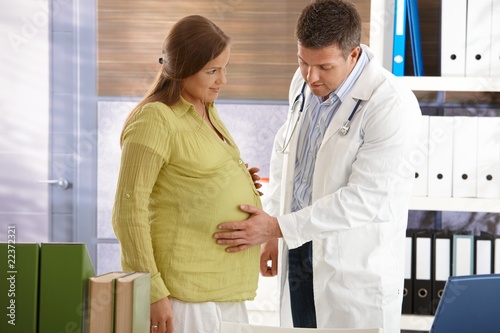 Photo: Doctor examining pregnant woman Doctor examining pregnant woman