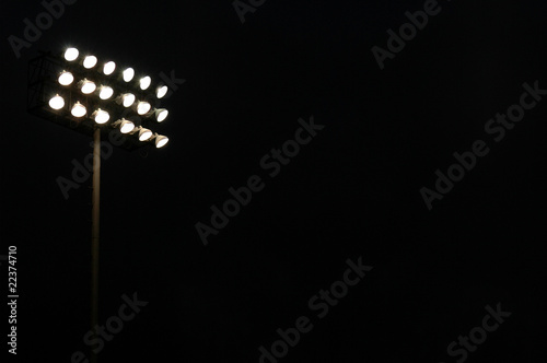 Photo: Stadium lights on a sports field at night with copy space Stadium lights on a sports field at night with copy space