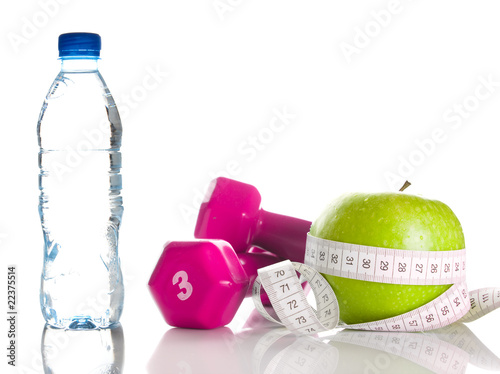 Photo: Dumbbells, apple, measure tape and bootle of water Dumbbells, apple, measure tape and bootle of water