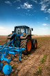 Photo: The Tractor - modern farm equipment in field The Tractor - modern farm equipment in field