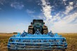 Photo: The Tractor - modern farm equipment in field The Tractor - modern farm equipment in field