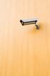 Security camera over brown background