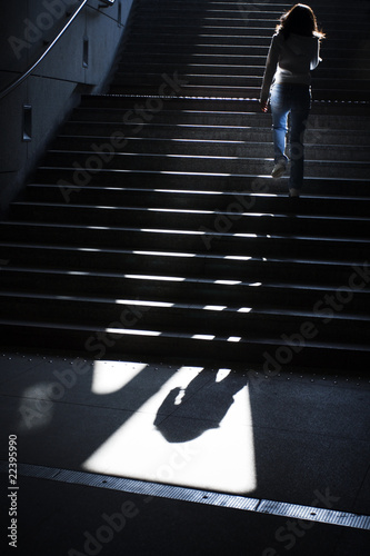 Photo: Girl going upstairs in subway Girl going upstairs in subway