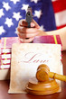 Hand with gun and judges gavel