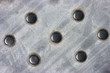 Brushed steel plate with raised studs