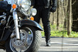 Biker stands near his bike Biker stands near his bike