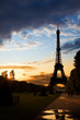 Eiffel Tower against a colorful sunset after rain