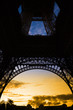 Orange sunset under Eiffel Tower arches