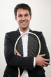 junger business mann mit tennisschläger