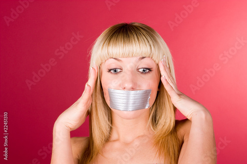 Photo: Young blond woman having a headache close up Young blond woman having a headache close up