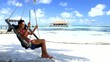 Beautiful and sexy woman resting at Maldives seaside