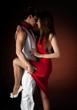 Young couple dancing embrace passion romance on dark red light