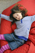Photo: Young girl lying on beanbag Young girl lying on beanbag
