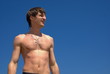 Young man on blue sky background