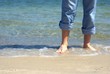 Man barefoot on the beach
