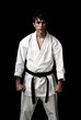 High Contrast karate male fighter on black background.
