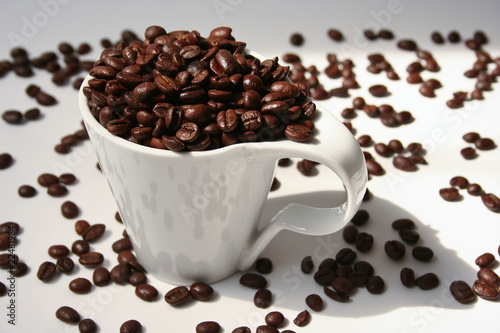 Photo: Fresh coffee beans in a white cup Fresh coffee beans in a white cup
