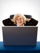 businesswoman sitting in armchair by the laptop
