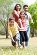 Foto: Happy family having fun in the park Happy family having fun in the park