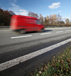 Red delivery/cargo van going fast on a highway