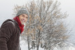 Young man in winter clothes smiling at camera