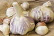 Garlic cloves on a hessian background.
