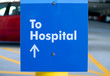 Sign in parking garage.arrows the direction to hospital.