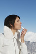 Young woman applying lip balm