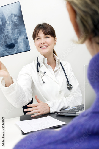 Photo: patient and female doctor examining an X-ray patient and female doctor examining an X-ray