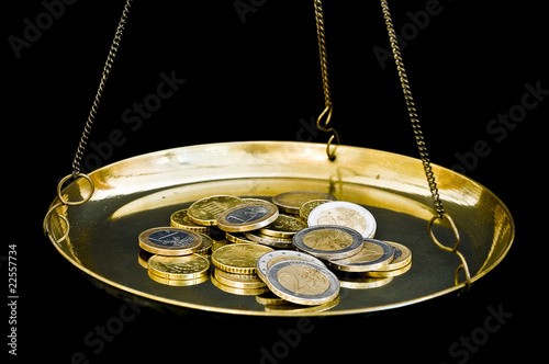 Photo: Euro coins on scales Euro coins on scales
