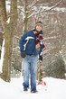 Man Pulling Sledge Through Winter Landscape