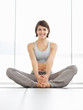 Happy and fit young woman practicing yoga