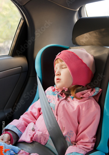 Photo: Cute little girl sleeping in a car Cute little girl sleeping in a car