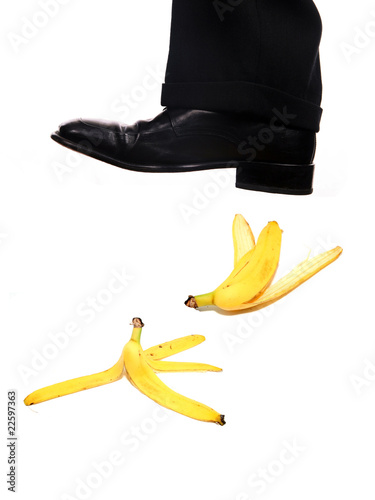 Photo: businessman shoe steping a banana businessman shoe steping a banana