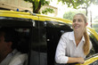 happy female passenger inside of a taxi