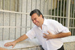 Photo: Sudden chest pain: Man having a heart attack bending Sudden chest pain: Man having a heart attack bending