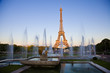 Eiffel tower behind Trocadero fountains, under last rays of sun