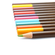 Colored pencils and a unique green on a white background