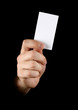 Hand with black business card on black background
