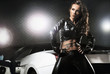 Sexy woman posing next to sport car