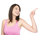 Young attractive female pointing at copyspace
