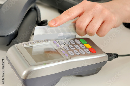 Photo: Hand with credit card swipe through terminal for sale Hand with credit card swipe through terminal for sale