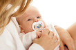 Newborn baby with dummy